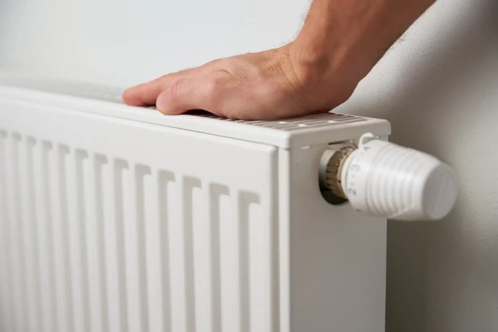 Engineer repairing central heating system and radiators
